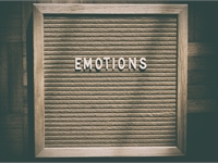 The word emotions in letters on a board