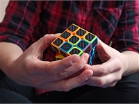 hands solving a Rubik's cube